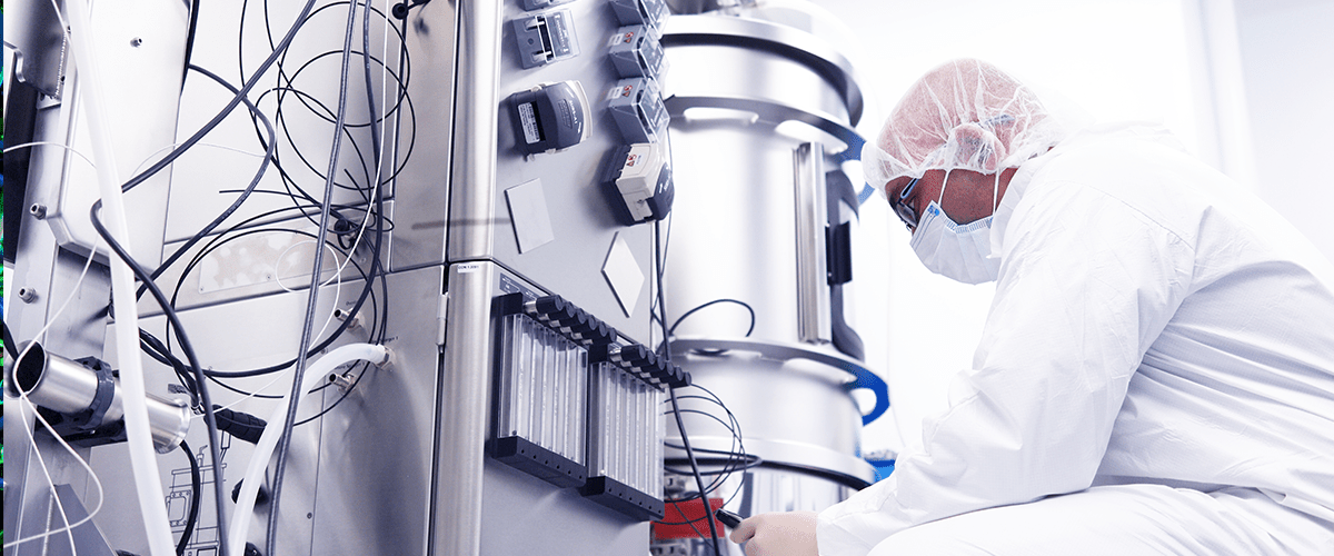 Man investigating bioreactor.